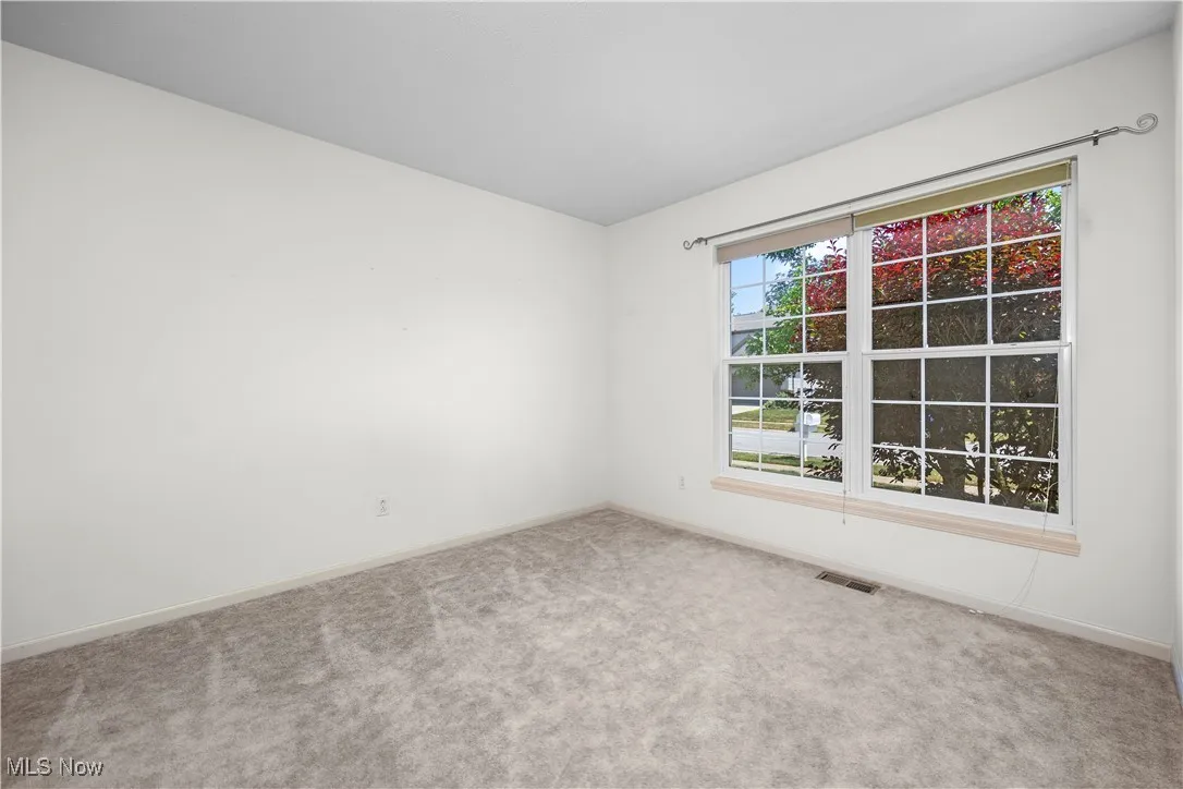 Carpeted empty room with baseboards