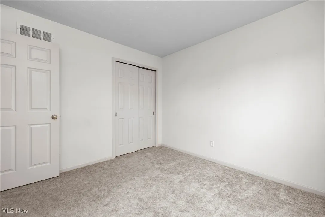 Unfurnished bedroom featuring carpet floors and a closet