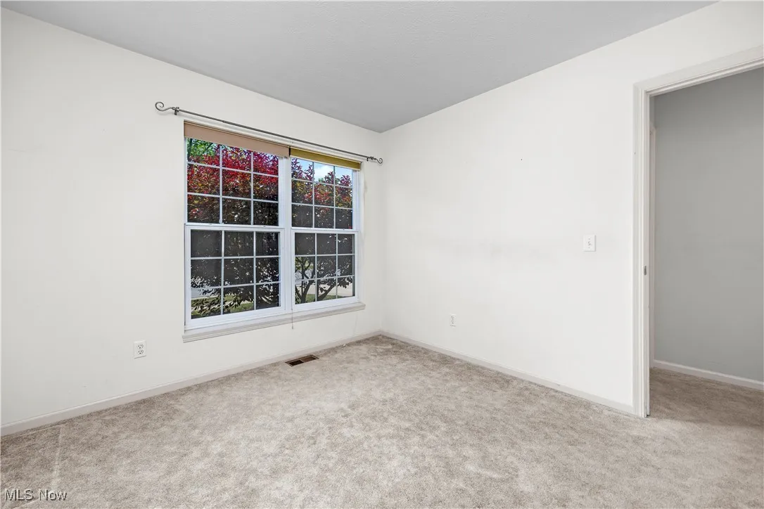 Carpeted spare room with baseboards