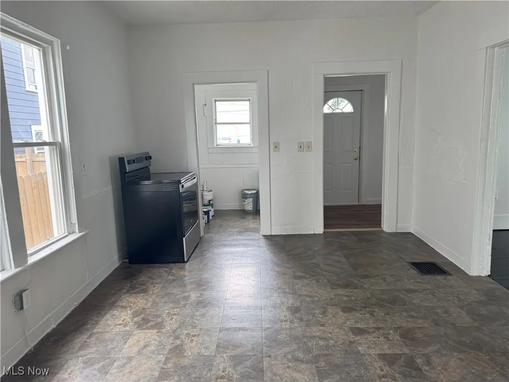 Laundry area featuring stone finish floors