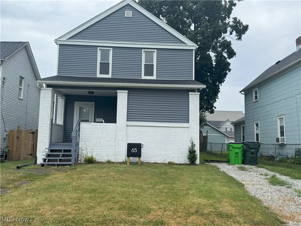 View of front of home with covered porch and brick siding
