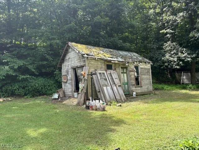 View of shed featuring a wooded view