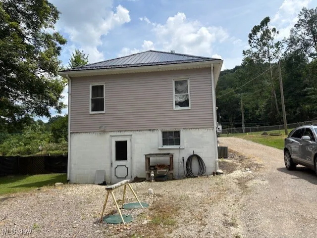 Rear view of house featuring a metal roof