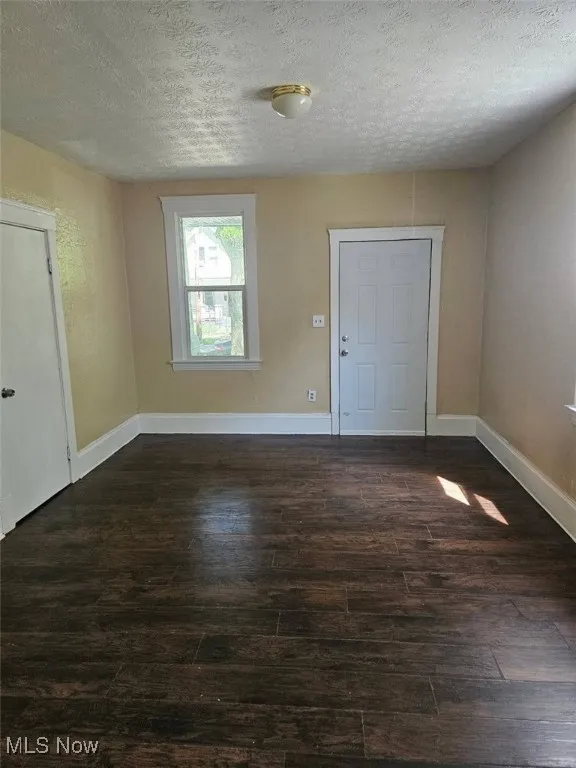 Foyer entrance featuring wood finished floors and a textured ceiling