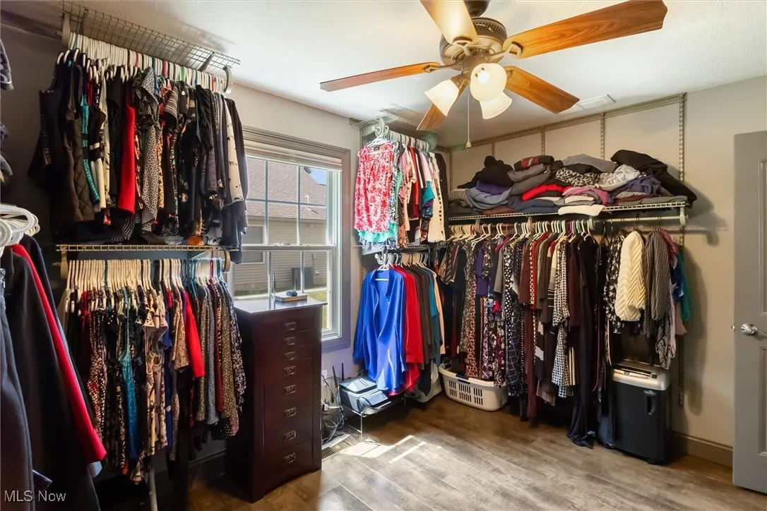 Spacious closet with ceiling fan and wood finished floors