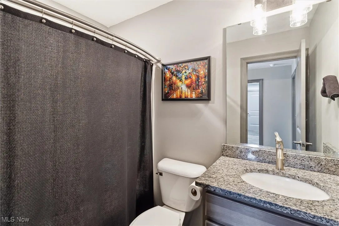 Bathroom featuring vanity and curtained shower