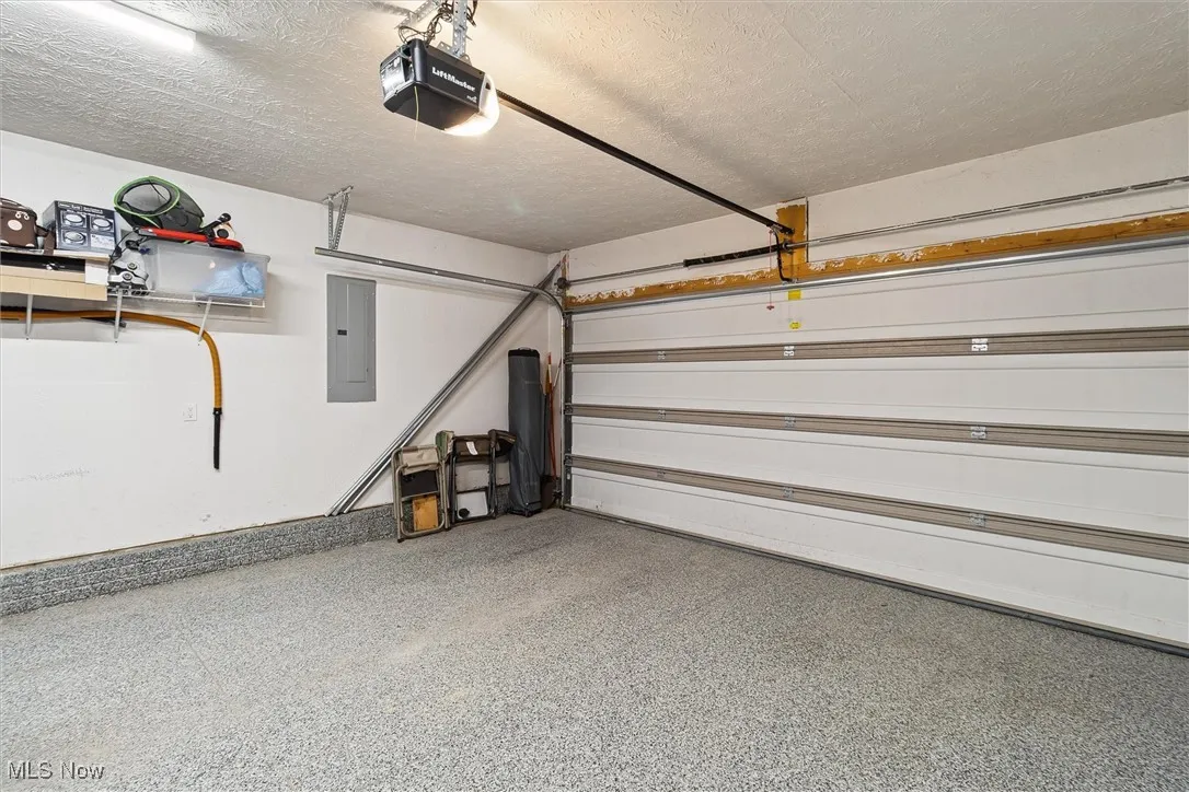 Garage with a garage door opener and electric panel