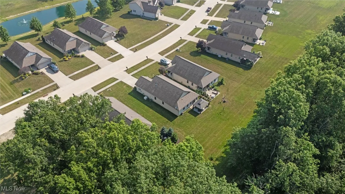 View of property location featuring a large body of water and nearby suburban area