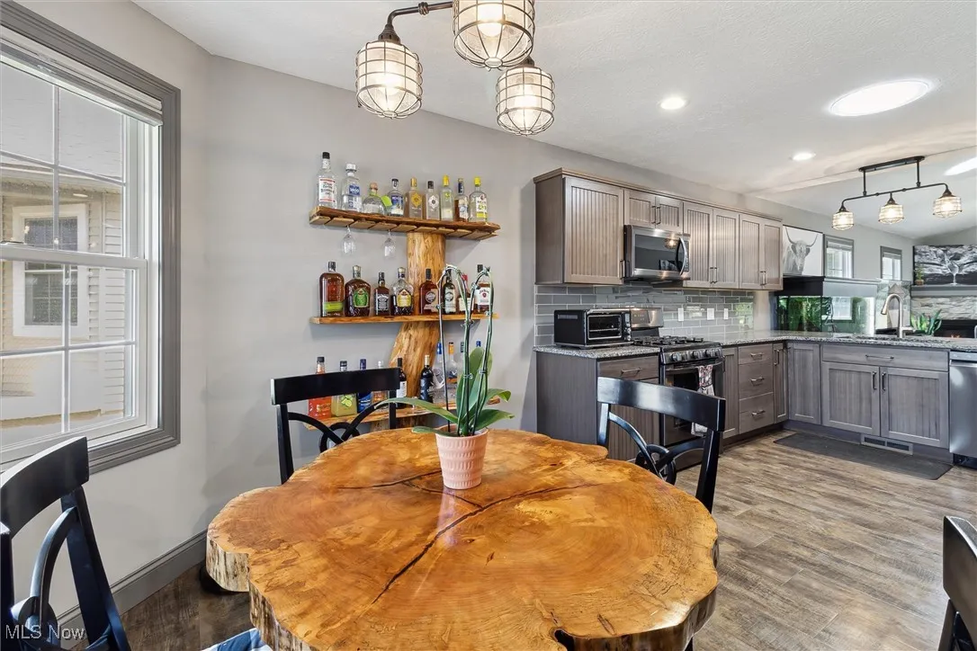 Dining area with wood finished floors, healthy amount of natural light, and recessed lighting