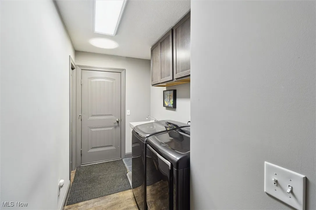 Laundry area featuring cabinet space and washer and dryer