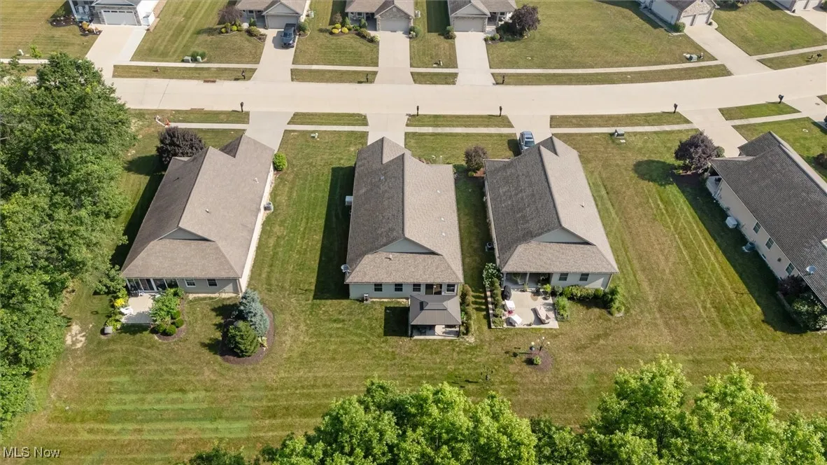 Aerial view of property and surrounding area with nearby suburban area
