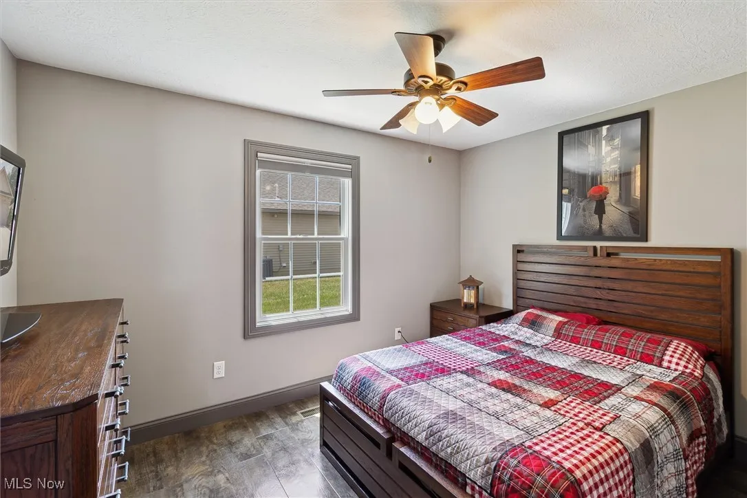 Bedroom featuring dark wood finished floors and ceiling fan