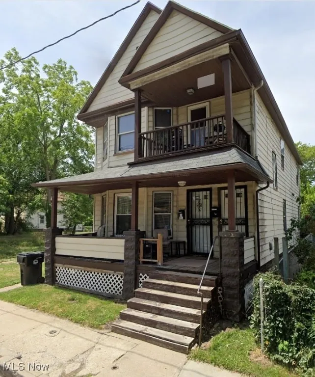 View of front of house featuring a balcony and covered porch