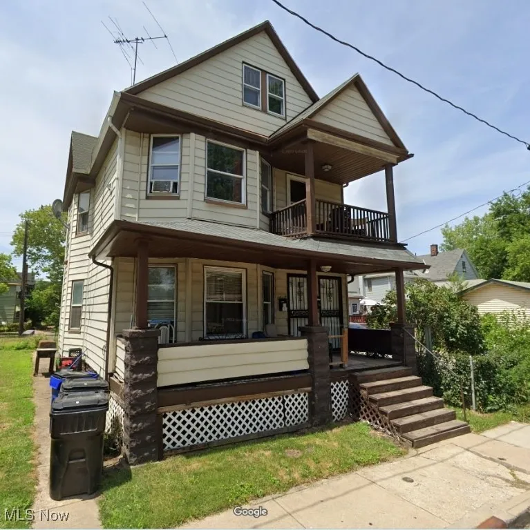 View of front of house featuring a porch and a balcony