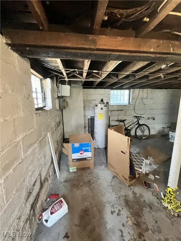 Basement with gas water heater and healthy amount of natural light