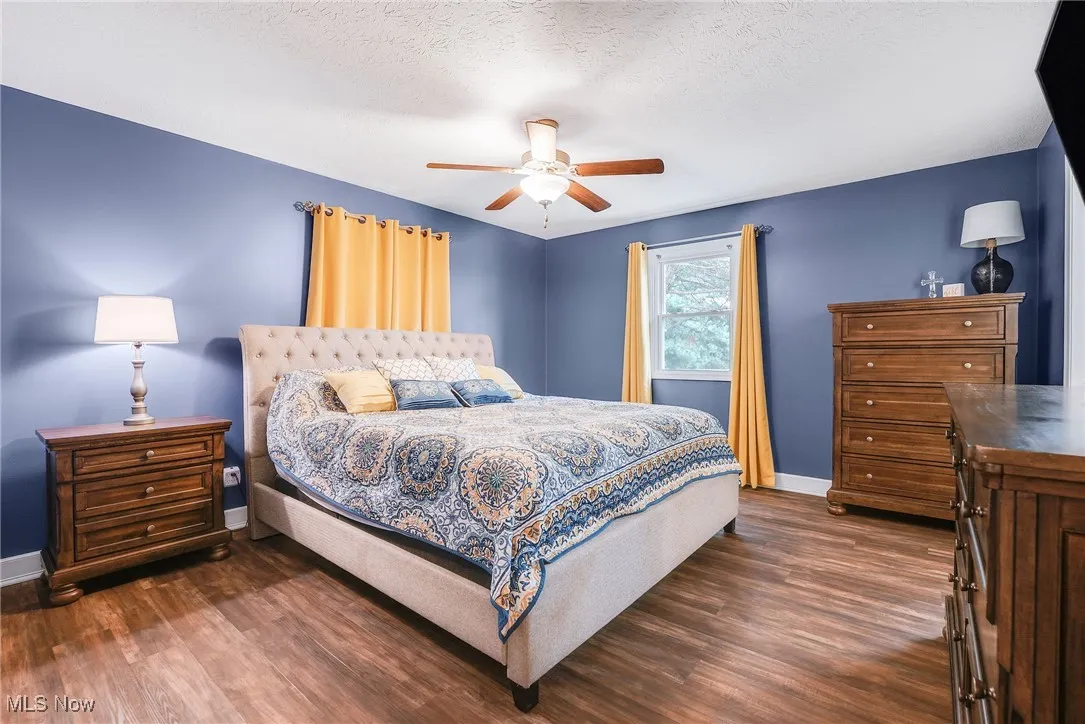 Bedroom with luxury vinyl  floors and ceiling fan