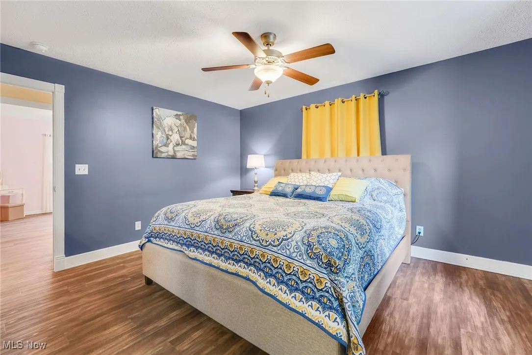 Bedroom with vinyl vinyl  floors and a ceiling fan
