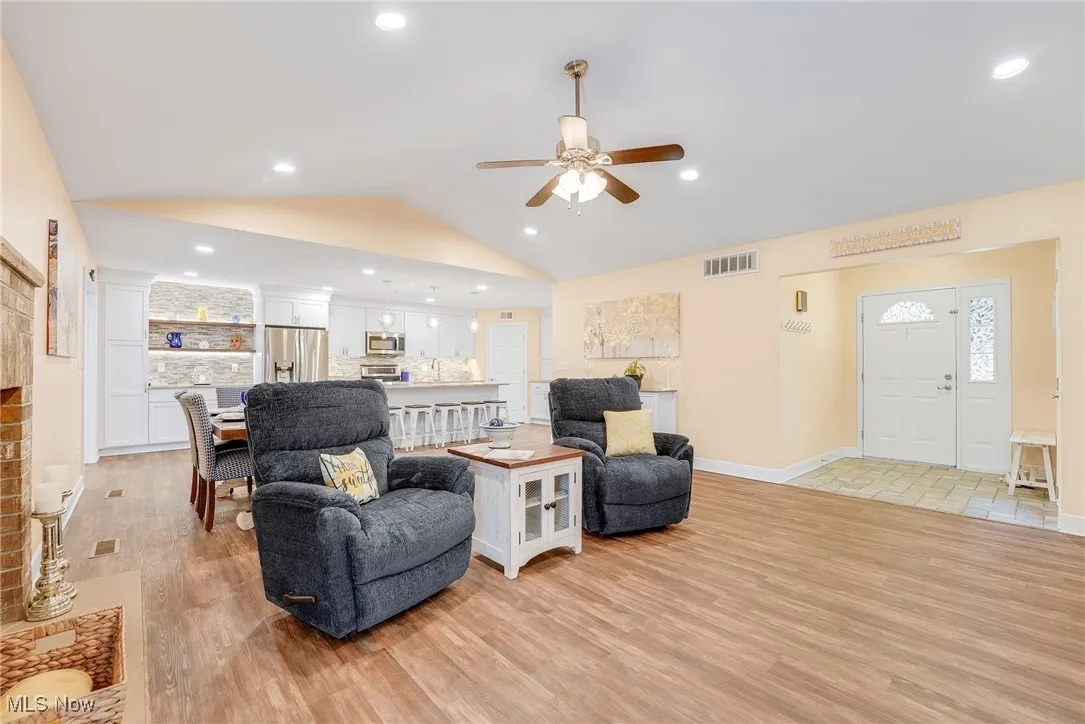Living area featuring vaulted ceiling, a ceiling fan, luxury vinyl floors, and recessed led  lighting