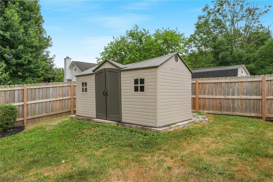 View of shed with a fenced backyard