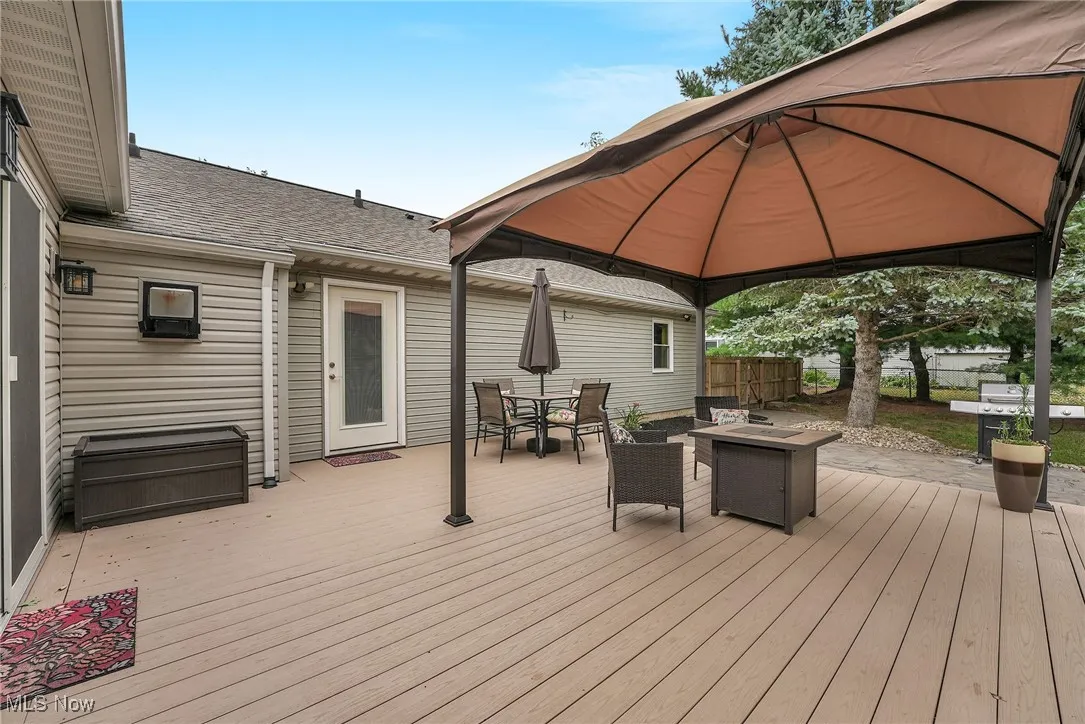 Trex Deck with outdoor dining area, a gazebo, and an outdoor fire pit