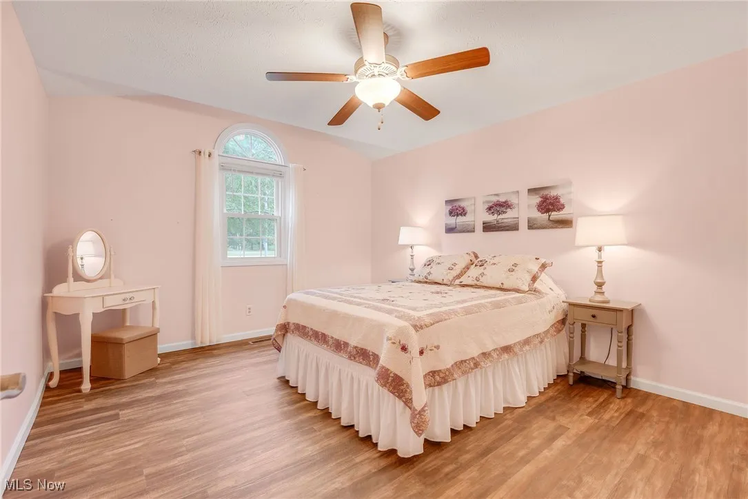 Bedroom featuring luxury vinyl floors and ceiling fan