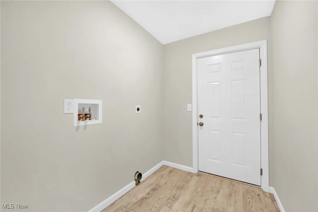 Laundry area featuring hookup for a washing machine, light wood finished floors, and electric dryer hookup