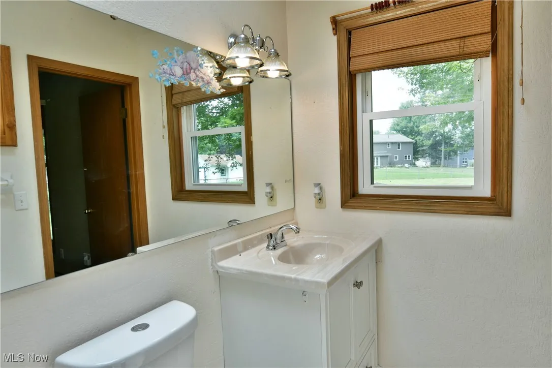 Bathroom featuring a chandelier and vanity