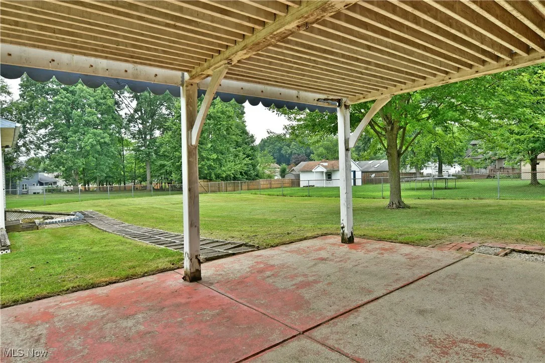 Fenced backyard with a patio