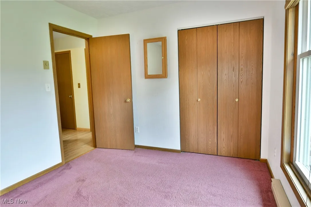 Unfurnished bedroom with carpet floors and a closet