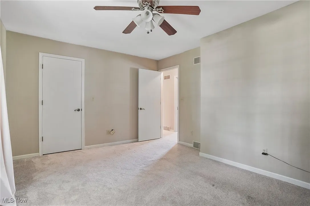 Unfurnished bedroom with carpet floors and a ceiling fan