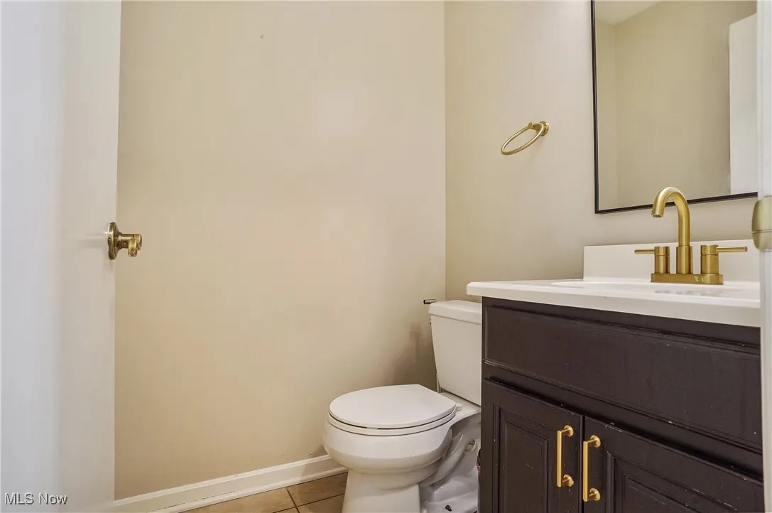 Bathroom with tile patterned floors and vanity