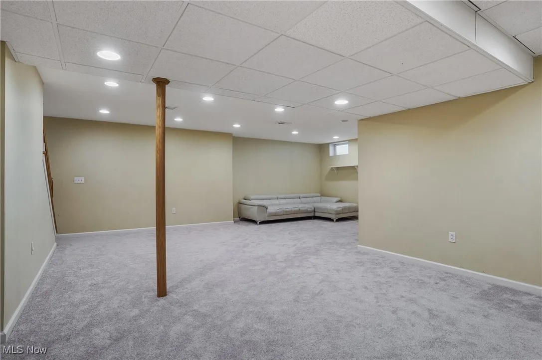 Finished basement with recessed lighting, carpet floors, and a paneled ceiling