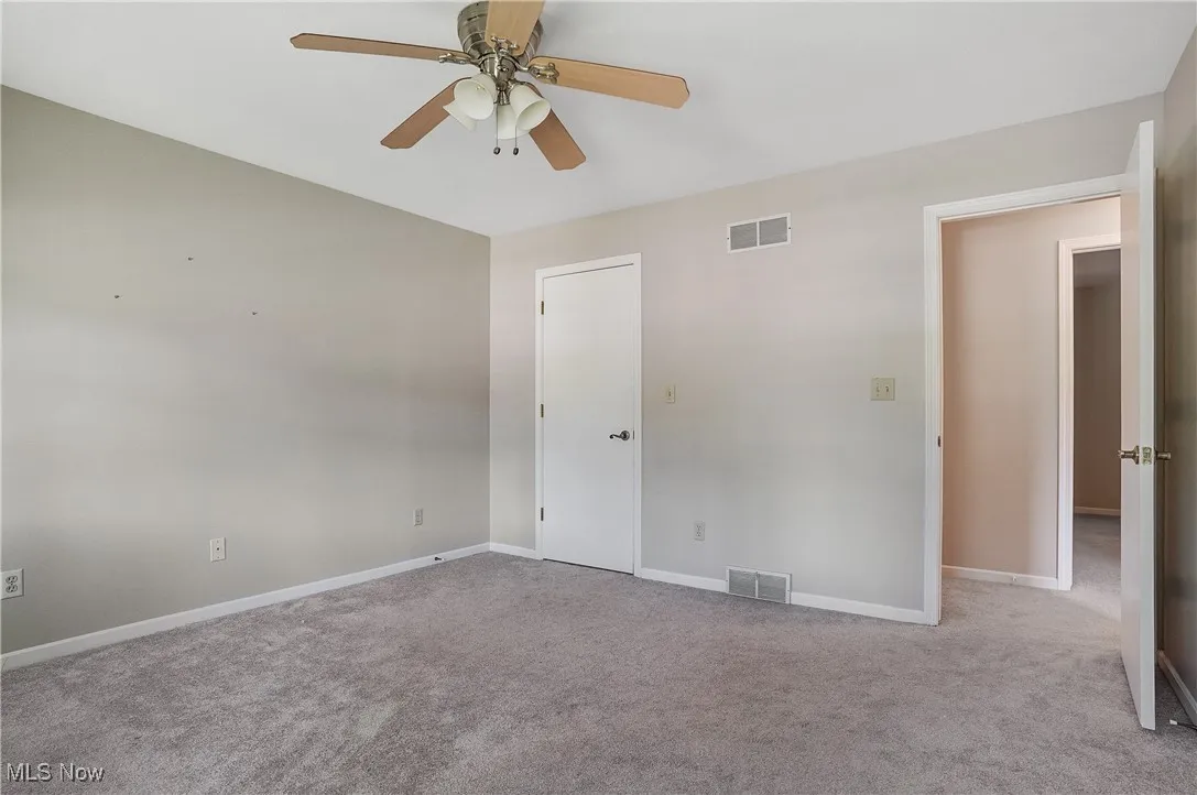 Unfurnished bedroom with carpet floors and ceiling fan