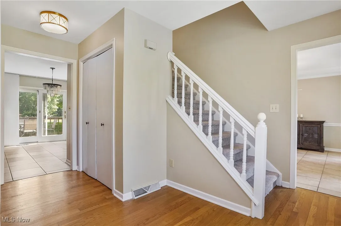 Stairway featuring wood finished floors and baseboards