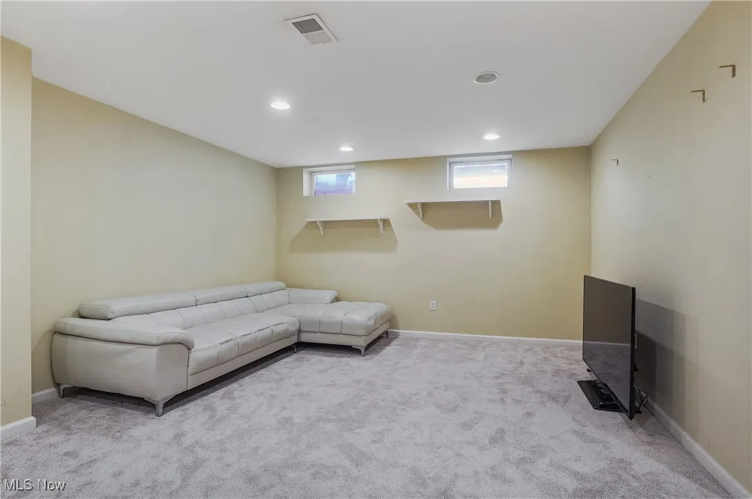 Sitting room with carpet and recessed lighting