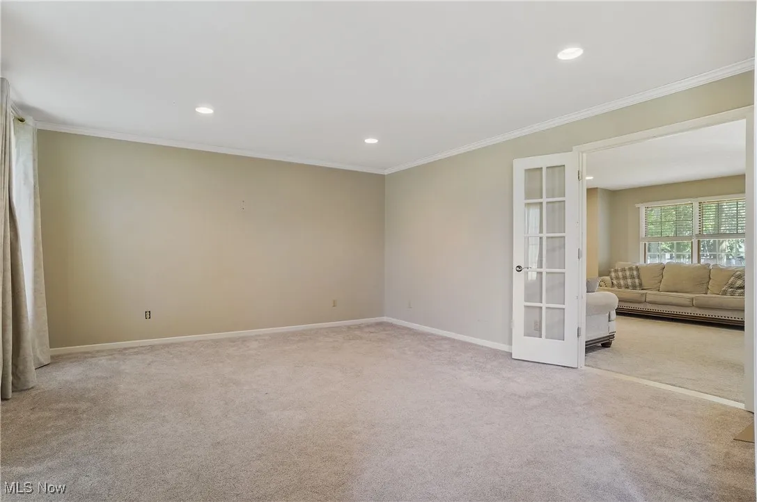 Unfurnished room with french doors, carpet flooring, crown molding, and recessed lighting