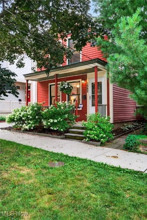 View of front of house with a front lawn and covered porch