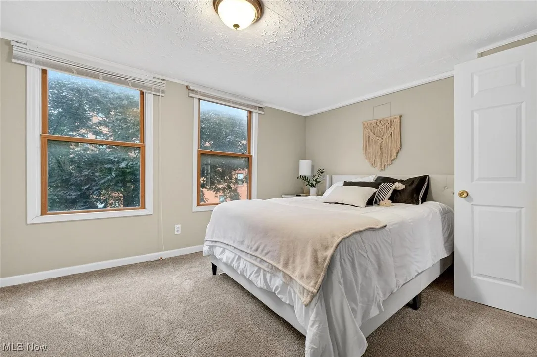 Bedroom featuring carpet and a textured ceiling