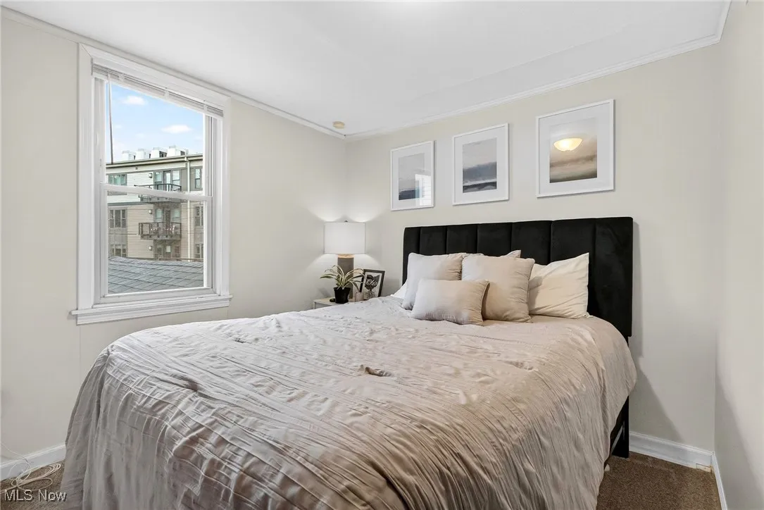 Bedroom with carpet flooring and crown molding