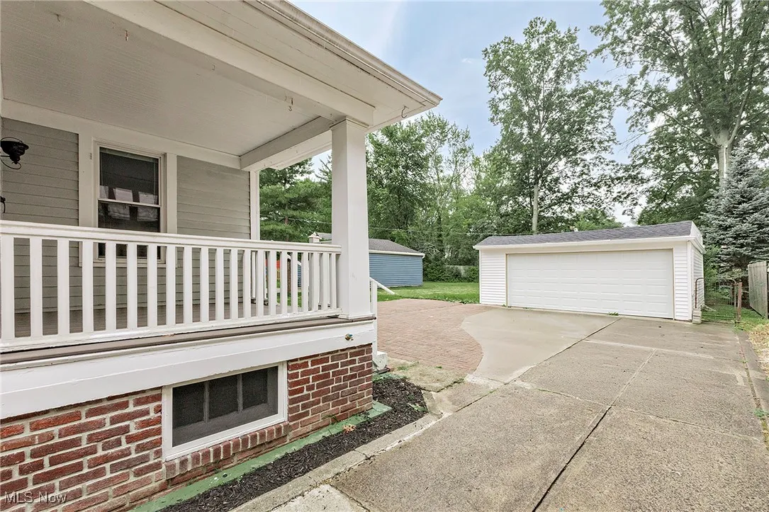 A view of the back porch and detached garage.