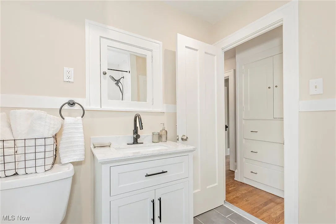 Another view of the updated full bath and view to the hallway and built in storage.