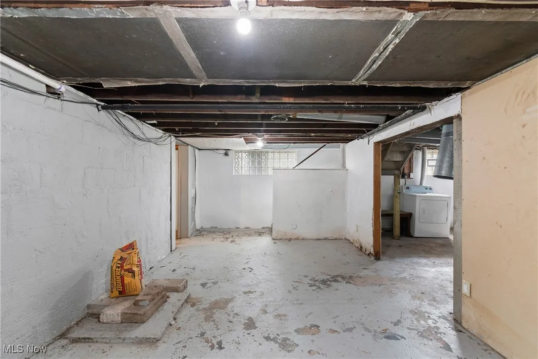 Basement with healthy amount of natural light and washer / clothes dryer