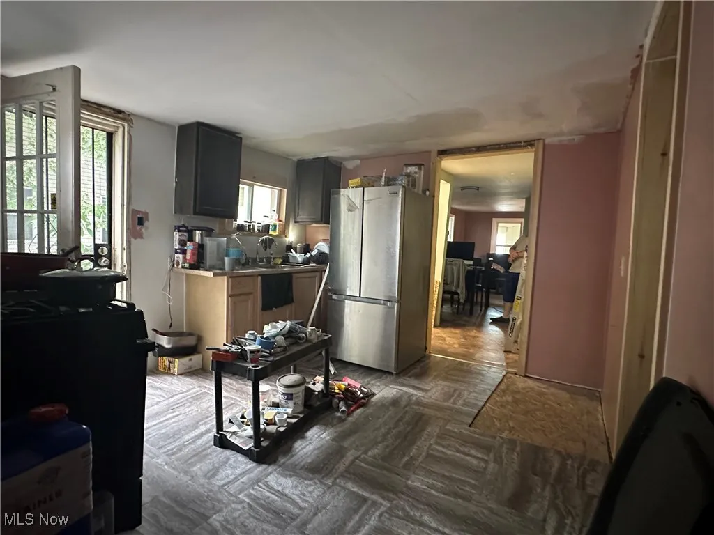 Kitchen with freestanding refrigerator and healthy amount of natural light