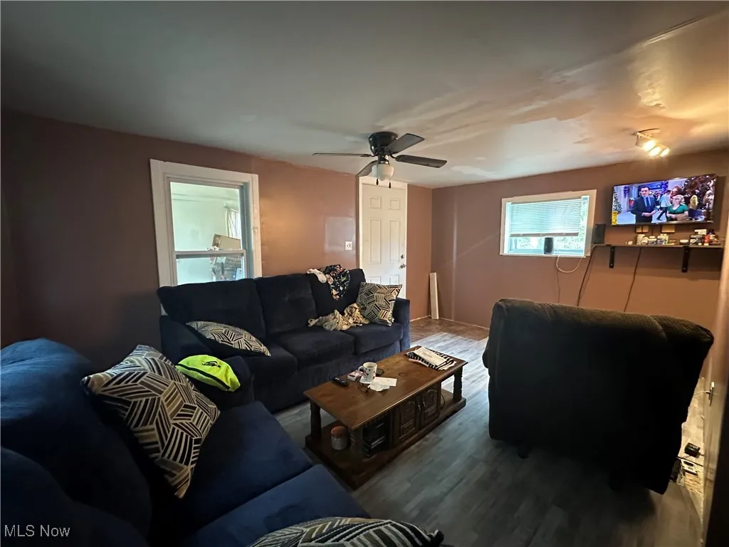Living area with a ceiling fan and wood finished floors