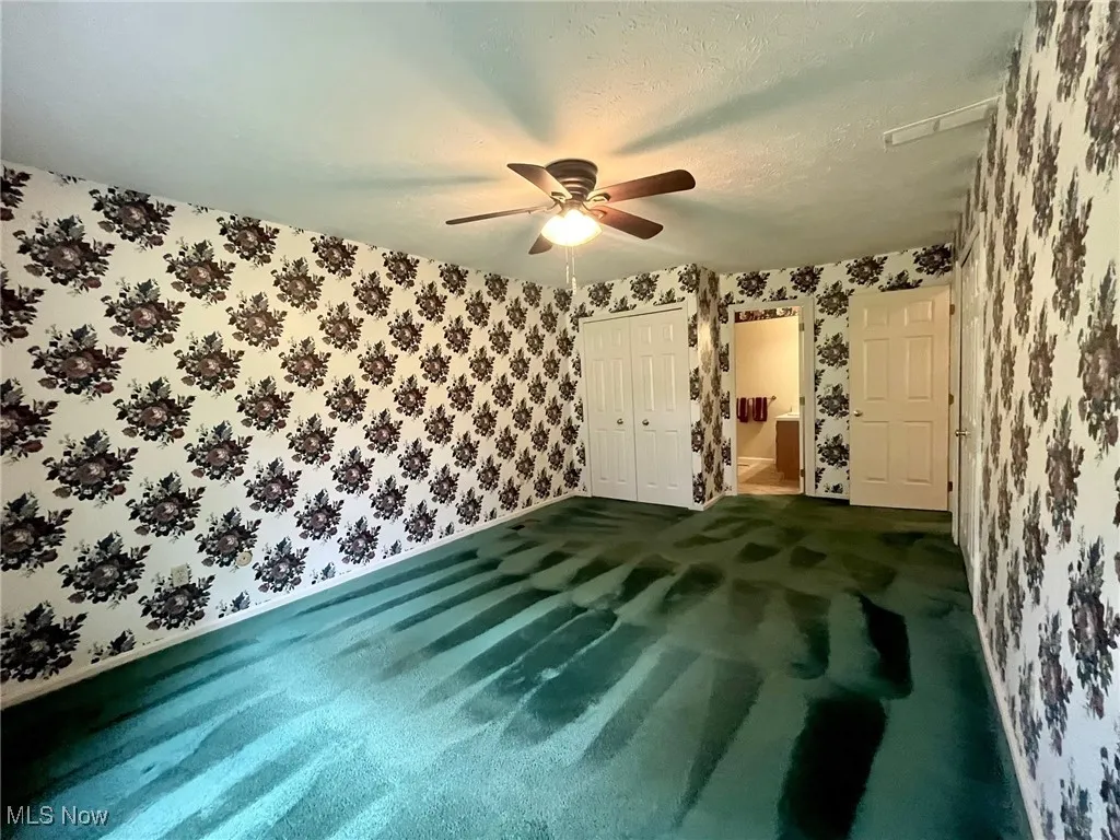 Primary Bedroom with view of closet door and primary bath entrance