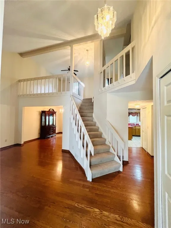 Entry view of stairs with a high ceiling.