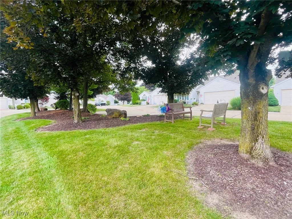 View of common grassy area by additional parking spaces for guests