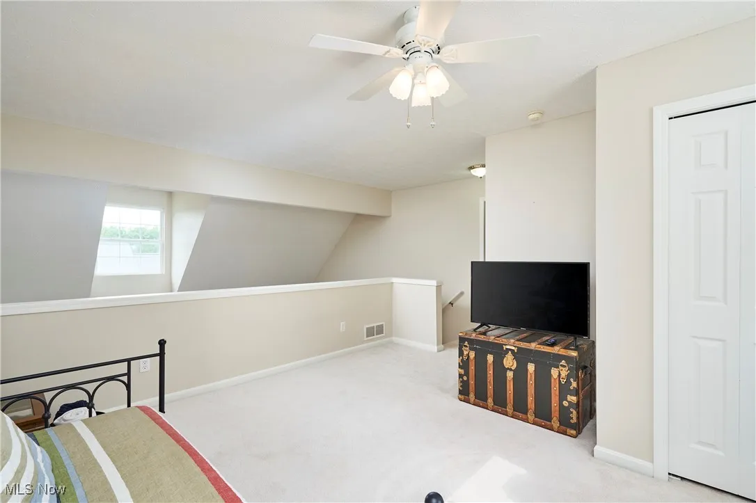 View from loft toward front of unit and stairs.