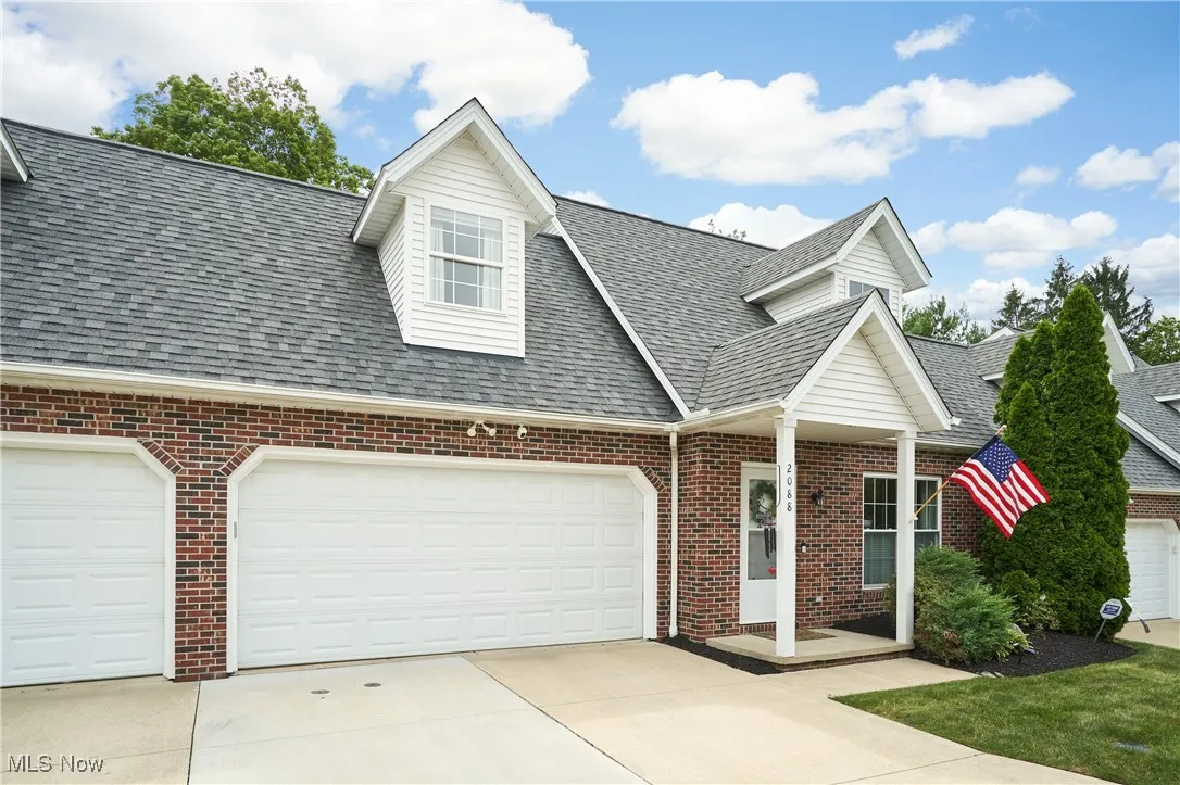 This cape cod shares the garage side with one other property.