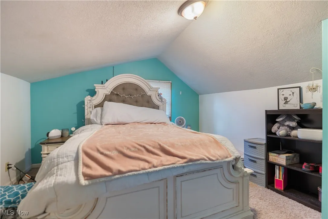 23x10 Carpeted master bedroom featuring lofted ceiling on the second floor.